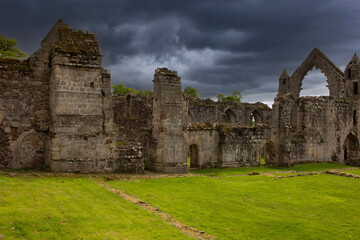 Fototapeta na wymiar Abbey ruins with storm clouds building in the background. British religious history concept.