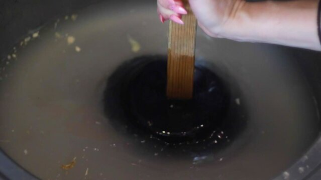 a woman clears a clogged sink with a plunger in the kitchen. housekeeping, maintaining hygiene in the kitchen, a woman cleans the water supply from blockage