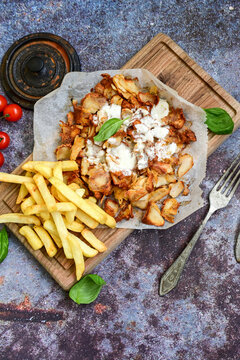  Portion of Spicy  kebab  Chicken  duner  gyros with french fries and garlic sauce  on  wooden board