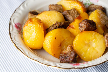 From traditional delicious Turkish food; potato and meat dish in casserole (Turkish name; Guvec tas kebabi, tandir)