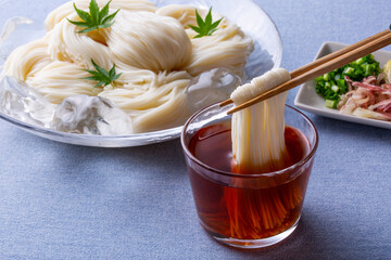 そうめんをめんつゆにつけて食べる