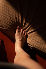 View of feet of a girl in the room in sunlight