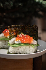Portion of japanese hand rolls with caviar and avocado