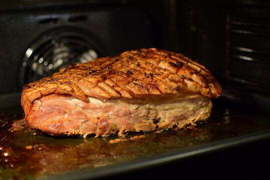 Ribbe, roasted pork ribs with skin, traditional Norwegian Christmas dish baked in the oven on a baking sheet