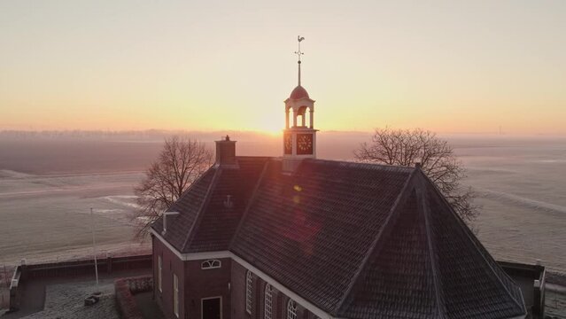The church of Unesco protected ancient former harbor of an island Schokland, misty morning, drone shot
