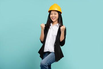 Beautiful Asian woman engineer developer hands up raised arms from happiness isolated on green background, Excited woman winner success concept