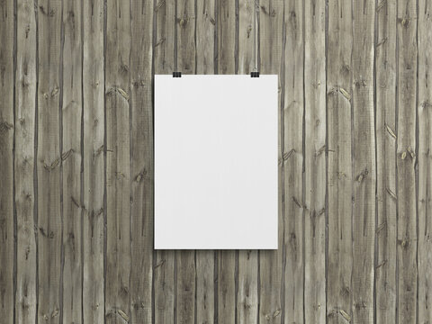 Blank vertical poster hanging with clips on a wood wall Mockup. 3D rendering