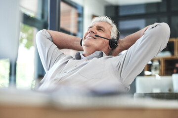Relax, telemarketing and mature professional at office on a break feeling calm at work. Contact us, call center and businessman with a happy smile with phone consultation and employee communication