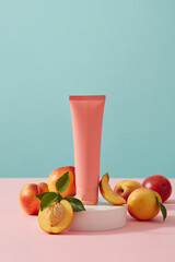 Beauty cosmetic container standing on round white pedestal with a peach slice. Natural organic beauty cosmetics concept. Light blue background