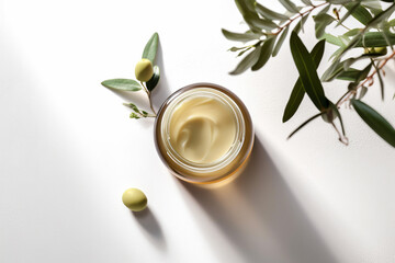Generative AI. Serum and moisturizing cosmetic cream with olive extract for skin with branch and olives on wood table. Top view. Natural cosmetics theme.Olive moisturizing cream