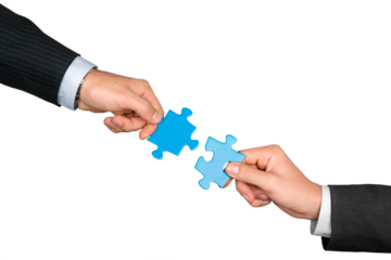 Closeup on Businesspeople Combining Puzzle Pieces Together