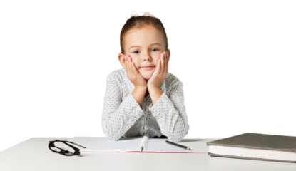 Sad girl with hands on face sitting at desk