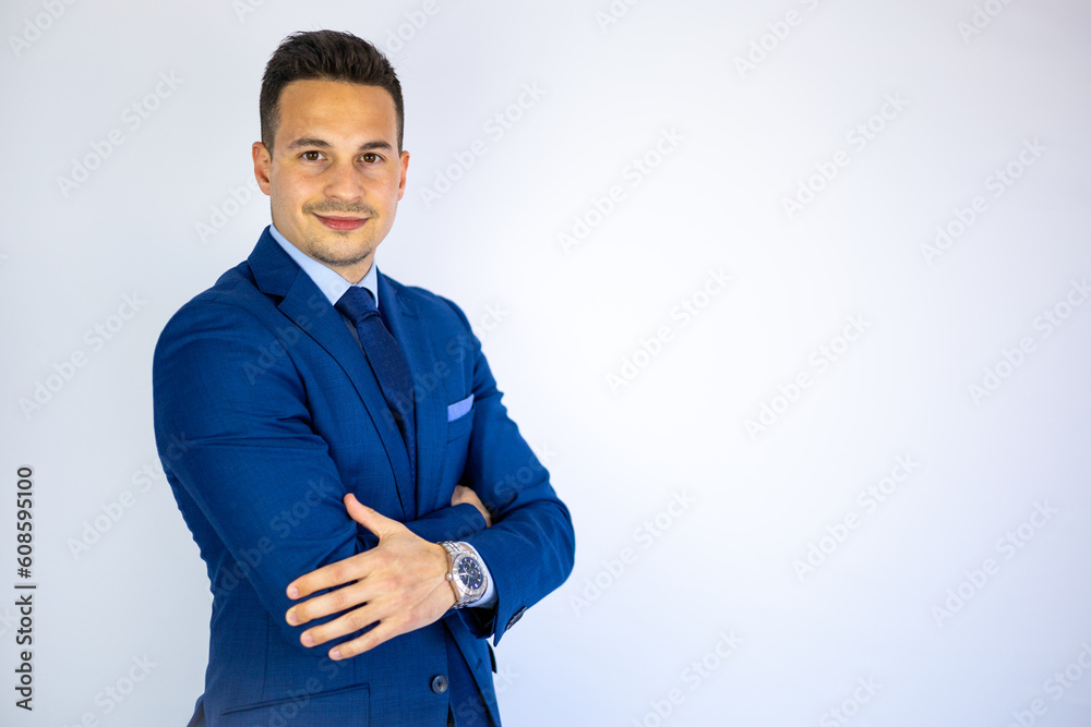 Wall mural young smiling business man wearing modern suit posing isolated on white background. handsome economi