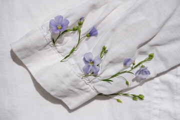 The sleeve of a white shirt with blue live fresh tickets grew flax from which fabric is made. White...