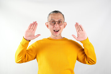 Portrait of Asian Man with yellow long sleeve shocked and happy

