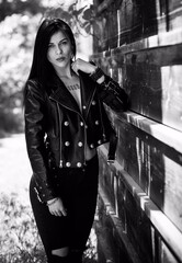 Grunge style, Beautiful sexy young woman with a dark long hair in leather jacket. Style of 90s