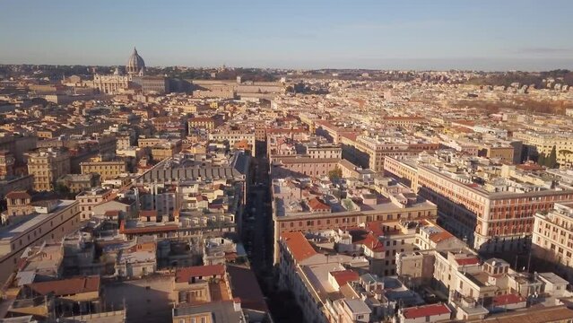 Aerial Cinematic drone downtown  Piazza Rome Italy birds flying past buildings, cars, traffic and streets of Vatican City St Peters Europe Sistine Chapel square morning left slowly movement