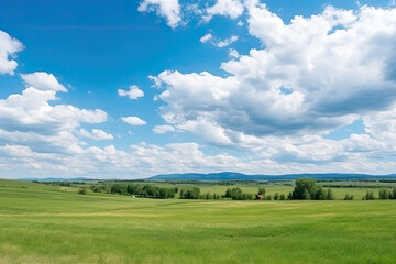 Obraz premium Green Farm Skyline Under Blue Sky and White Clouds