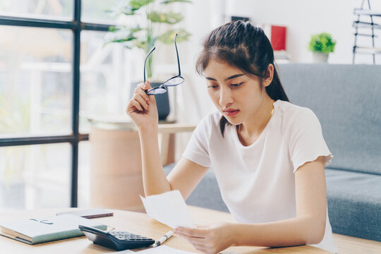 Woman Doing Finance At Home Office With Calculate Expenses And Savings. Saving Money And Finances Concept