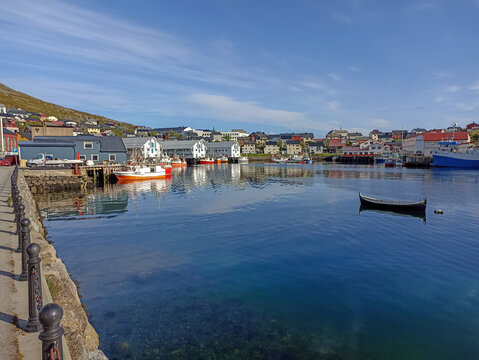 The harbor in Honningsvag town center reflected in the sea, Norway