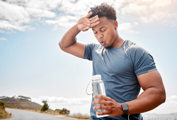 Fitness, outdoor and black man drinking water, tired and exercise with wellness, health and cardio training. Male person, guy or athlete outside, resting and liquid with practice, sweating and sports - Powered by Adobe