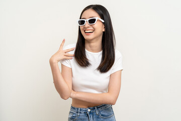 Naklejka premium Attractive Beautiful asian woman standing and posing. Sexy female smiling happy fashion wearing sunglasses on isolated background.