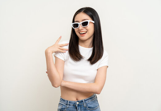 Attractive Beautiful asian woman standing and posing. Sexy female smiling happy fashion wearing sunglasses on isolated background.
