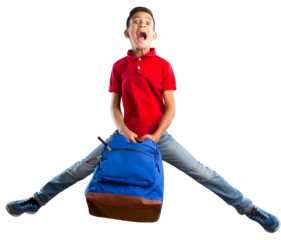 Happy young school child with backpack jumping