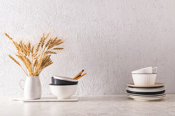 Kitchen beautiful background with a copy of the space in a minimalist style. plates and bowls on the countertop and a vase of ears.