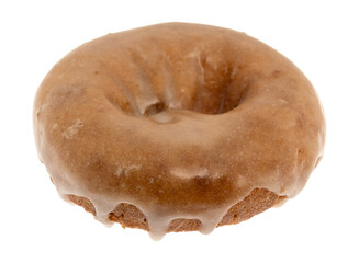Side view of a single whole freshly baked cake donut isolated on a white background.
