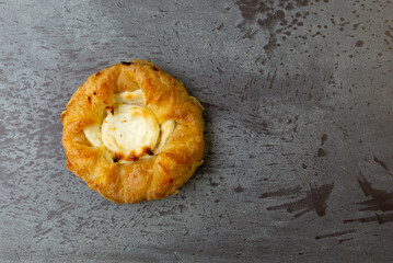 Top view of a delicious cream cheese danish on a gray mottled tabletop. - 608616799