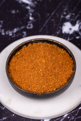 Cajun spice powder on dark background. Powdered dried cajun in bowl