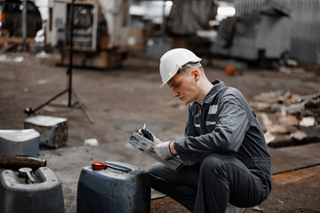 Industrial waste inspector examines the correct storage of hazardous chemicals, radioactive...