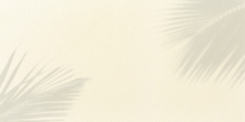 Panorama of texture wall with coconut palm leaf shadow on sand background.