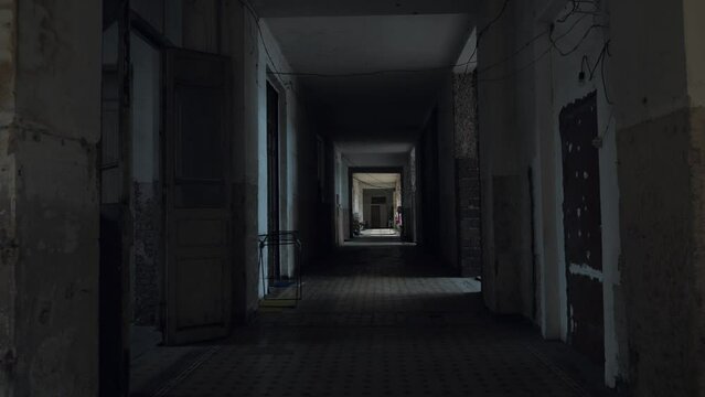 Corridor of abandoned ruined building inside which refugees now live as shelter.