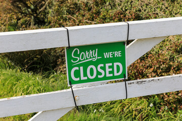 A sign on a wooden gate saying 'sorry we're closed', England, UK