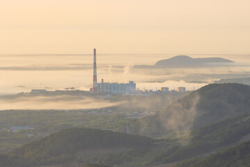 Beautiful morning industrial landscape. View of the thermal power plant. Fog over the valley and...