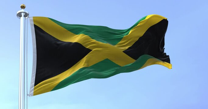 Slow motion loop of Jamaica national flag waving in the wind on a clear day