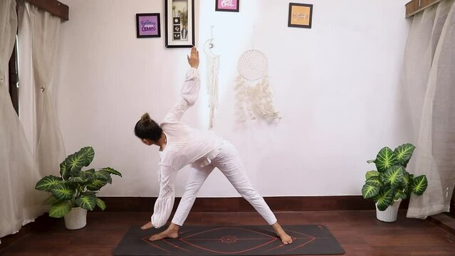 Video of a woman performing Parivrtta Trikonasana (Revolved Triangle Pose)