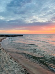 Purple twilights on the sandy beach, cloudy sunset seascape, pastel colors 