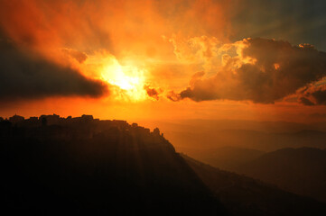reflexions of a sunset in the mountains and a castle at Sicilian town 