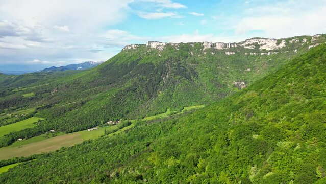 French countryside. Panoramic drone view of tree-covered hillsides of the heights of the Vercors, the marly hills and the valley Val de Drome, France