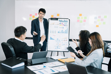 Asian businessman discuss with explaining a project, analyze planning and financial statistics and investment market at office.