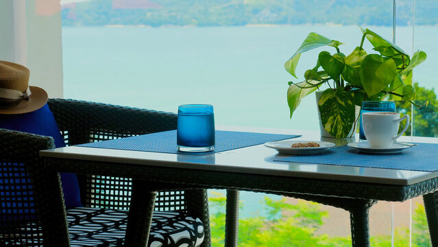 Enjoy luxury dining experience at picturesque waterfront restaurant cafe with stunning sea view. Elegant setting provides romantic and serene atmosphere for summer vacation.