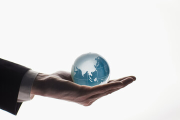 Businessman holding glass globe isolated on white background