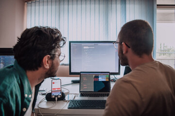 Programmers engrossed in deep collaboration, diligently working together to solve complex problems and develop innovative mobile applications with seamless functionality.
