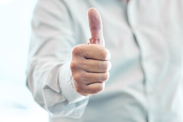 Businessman, hand and thumbs up for winning, approval or corporate success at the office. Hands of man with thumb emoji, yes sign or like for achievement, agreement or thank you at the workplace