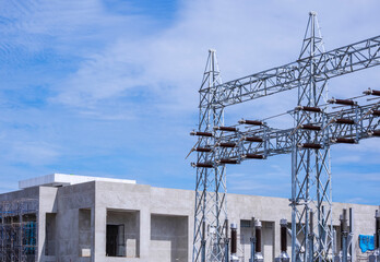 High voltage electric pylon structure with power distribution building substation under...