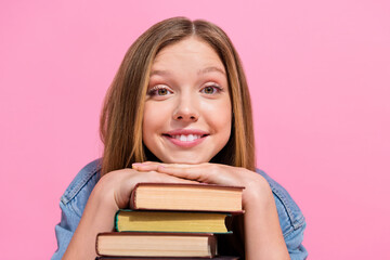 Close up photo of pretty smart lady wear trendy denim clothes hands under chin rejoice buy many books isolated on pink color background