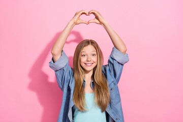 Fototapeta na wymiar Photo portrait of lovely young teenager lady raise hands heart shape gesture wear trendy jeans garment isolated on pink color background